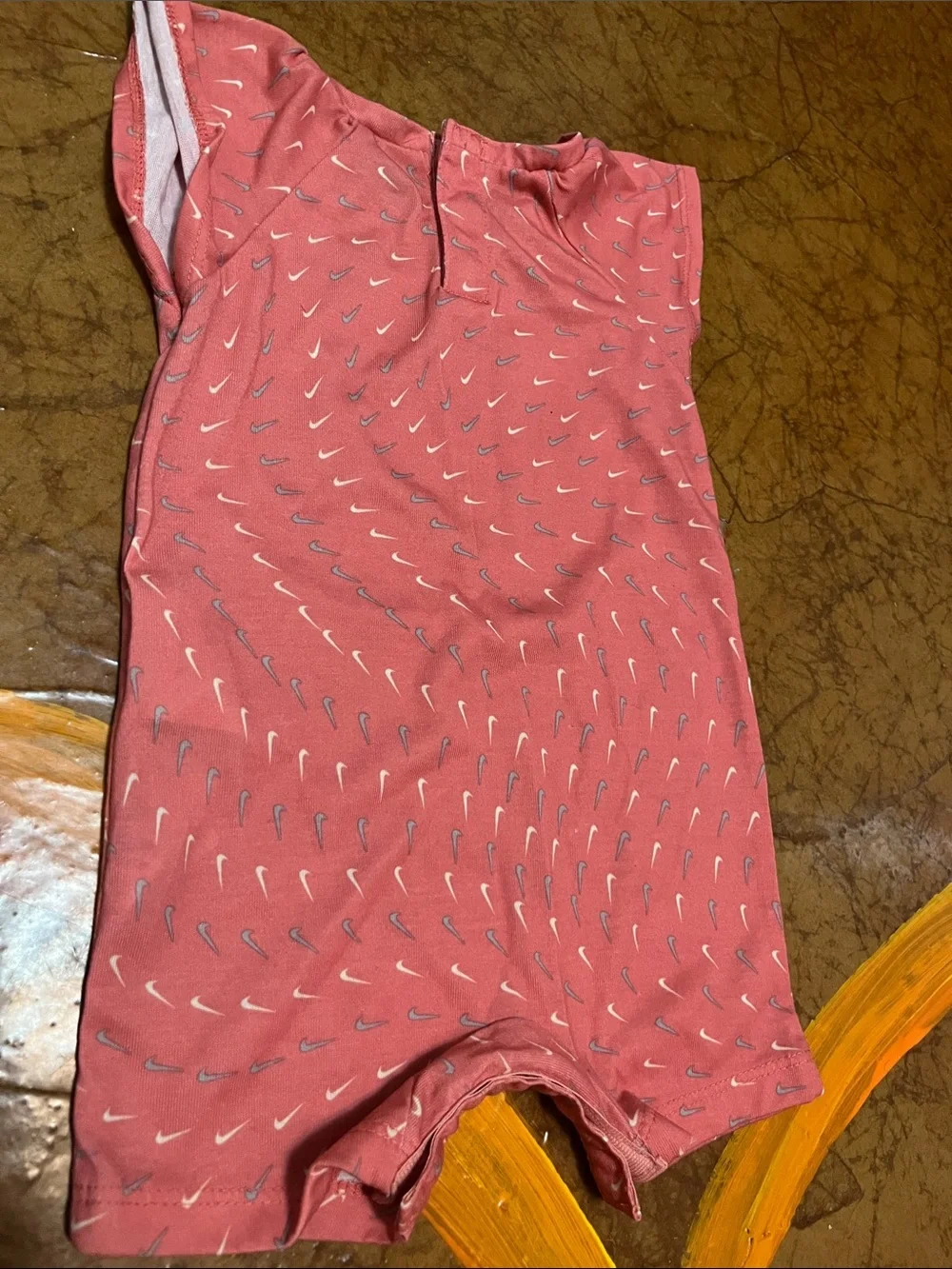 Nike Coral Pink Baby Romper with Repeat Swoosh Print